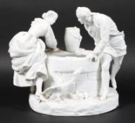 A Continental porcelain figure group beside a well, late 19th century,