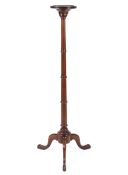 A Victorian mahogany torchere, raised on a turned fluted column,