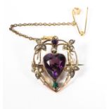 A late 19th century 9ct gold brooch with a central heart shaped amethyst surrounded by seed pearl