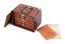 An early 20th century Chinese cased mahjong set with accessories and books