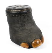 A Victorian taxidermy elephant foot stool, the foot surmounted with a black leather padded seat,