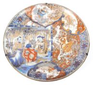 A large Japanese 19th century Imari charger decorated with three scholars in a bamboo grove,