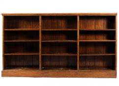 An early 20th century oak three section bookcase, with moulded top and plinth base,