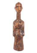 A carved wooden tribal figure of a woman,