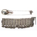 A late 19th century Omani white metal chain link bracelet mounted with hanging bells, 22cm long,