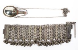 A late 19th century Omani white metal chain link bracelet mounted with hanging bells, 22cm long,