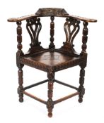 A Victorian carved oak corner chair,