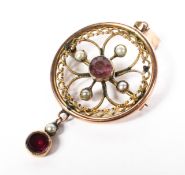 A 9ct gold circular pendant brooch set with garnets and seed pearls