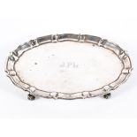 A George V silver footed salver of oval form with pie crust border,