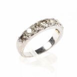 An early 20th century white metal half eternity diamond ring set with eight clawset brilliant cut