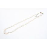 An early 20th single strand of graduated pearls on an unmarked yellow metal clasp,