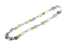 A strand of Mexican turquoise and Peridot free cut beads with carved Peridot separators.