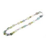 A strand of Mexican turquoise and Peridot free cut beads with carved Peridot separators.