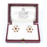 A pair of early 20th century 9ct gold garnet and seed pearl earrings of star shaped form,