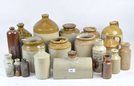 A large assortment of stoneware pots, in various shades of brown and cream,