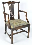 An early 20th century carver chair, the mahogany frame with a pierced back and curved structure,