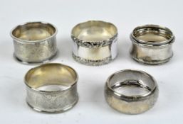 Five silver napkin rings, comprised of various sizes and designs,