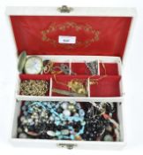 A vintage jewellery containing assorted costume jewellery, to include yellow metal chain,