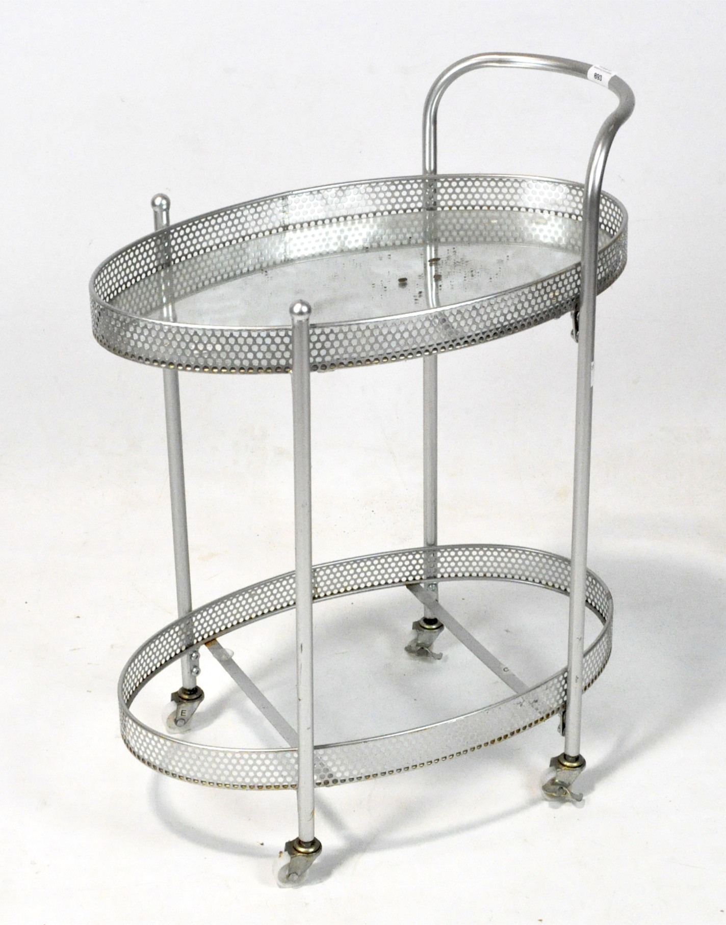 A 20th century metal trolley, of oval form with two shelves, pierced decoration and a single handle,