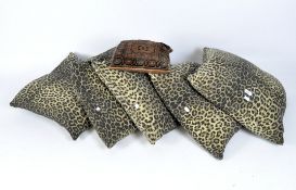 Five contemporary cushions, all with leopard print covers,