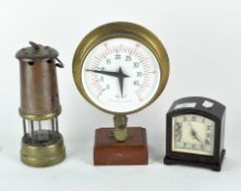 An antique coal miners lamp together with a Smiths mantle clock and a brass cased pressure gauge