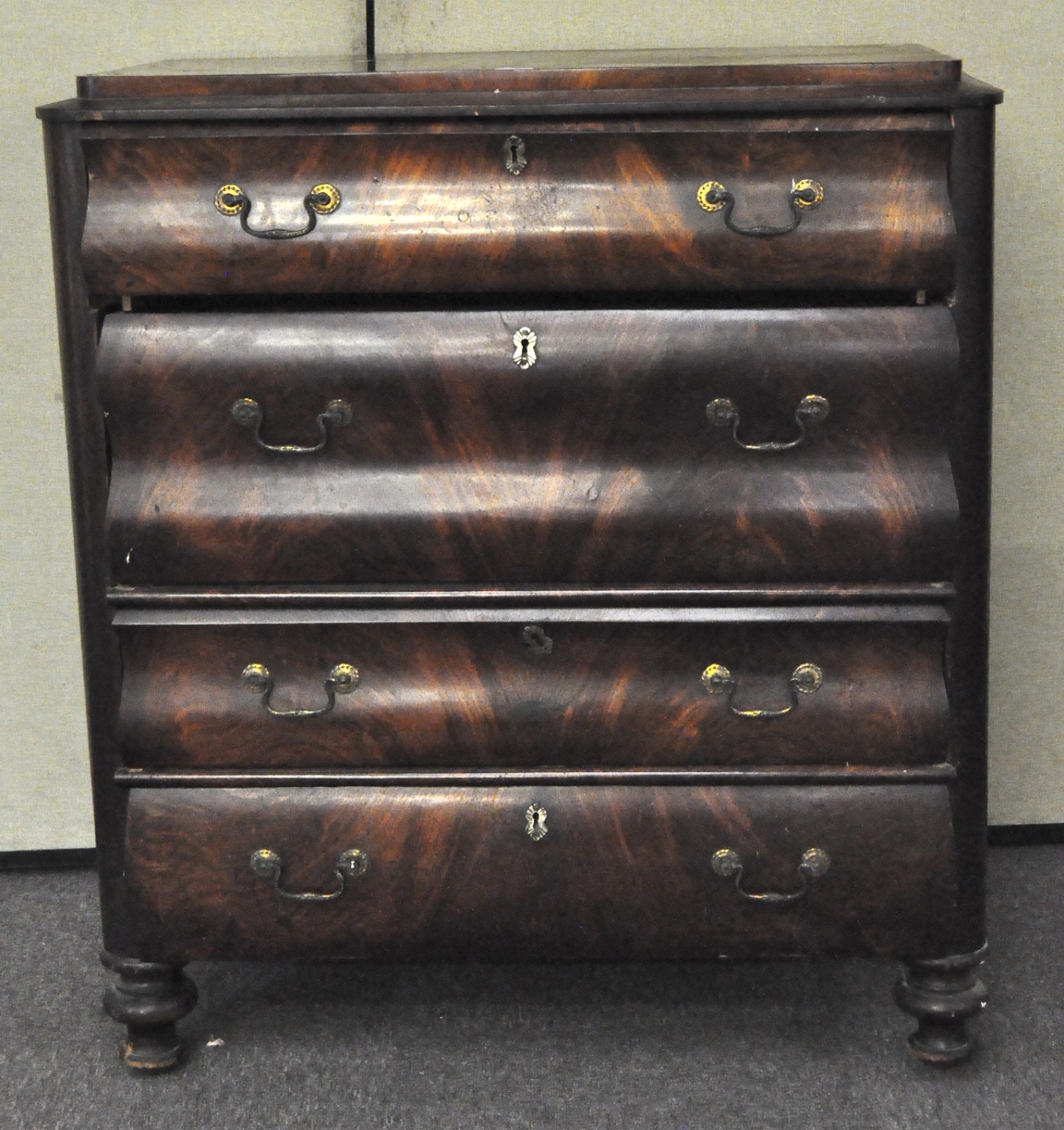 A late 19th/early 20th century veneered chest of drawers,