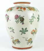 A Chinese style vase, the body decorated with fruit and vegetables on a cream crackle glaze ground,