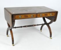A mahogany sofa table with two drawers with ring handles, on curule crossed supports,