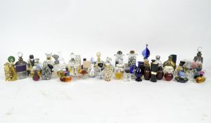 A large collection of small glass scent and perfume bottles, of assorted designs and colours,
