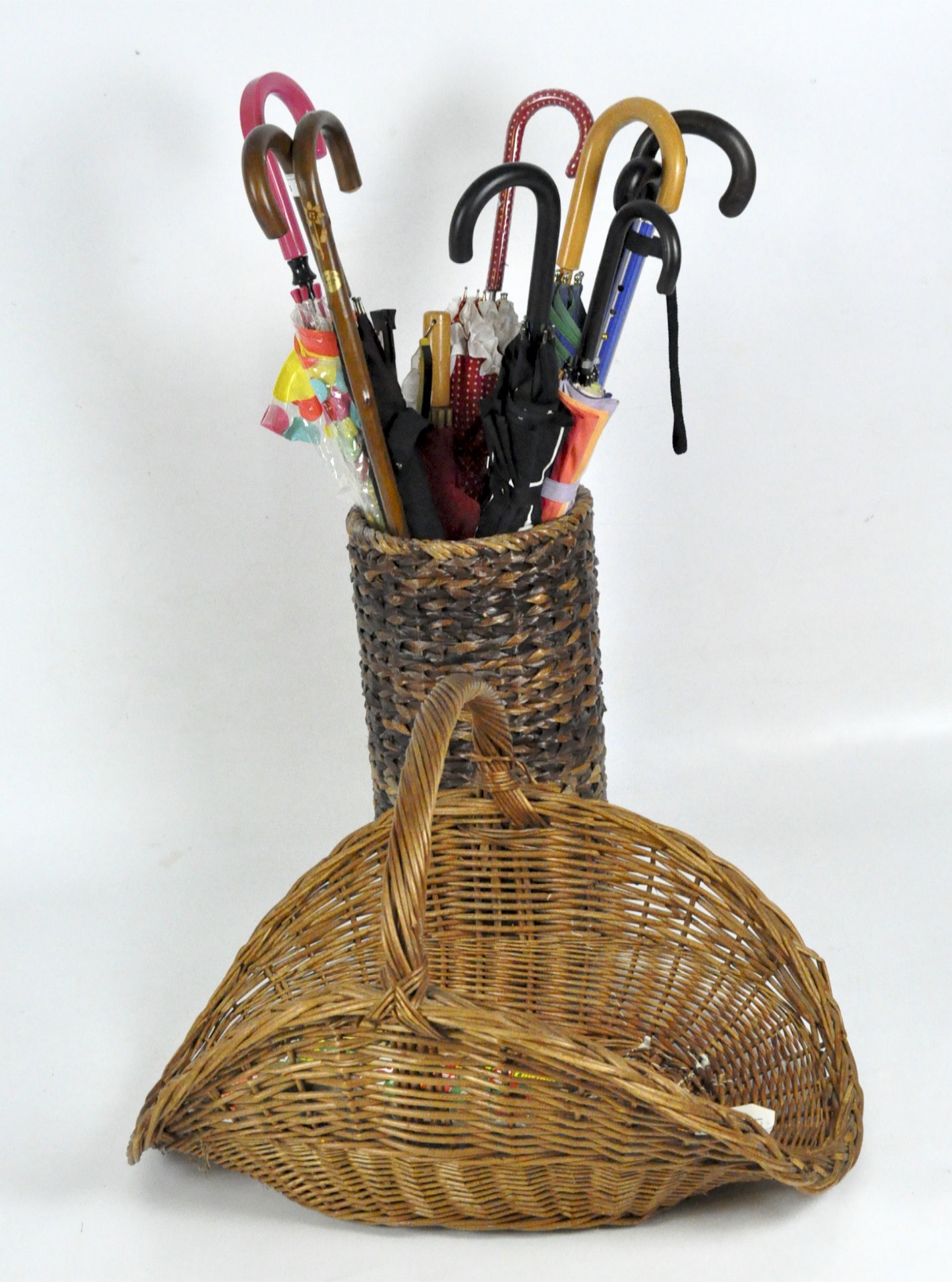 A 20th century wicker umbrella/walking stick stand, and a flower basket