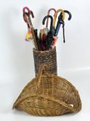 A 20th century wicker umbrella/walking stick stand, and a flower basket