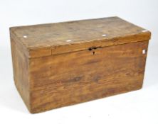 An antique pine blanket box, with a hinged lid,