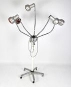 A retro lamp, composed of five individual lights, each positioned on the ends of moveable branches,