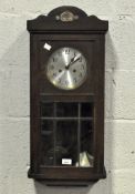 A early 20th century wall clock, the silvered dial with Arabic numerals,