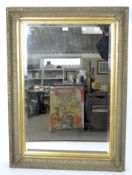 A large contemporary mirror in a moulded gilt frame,
