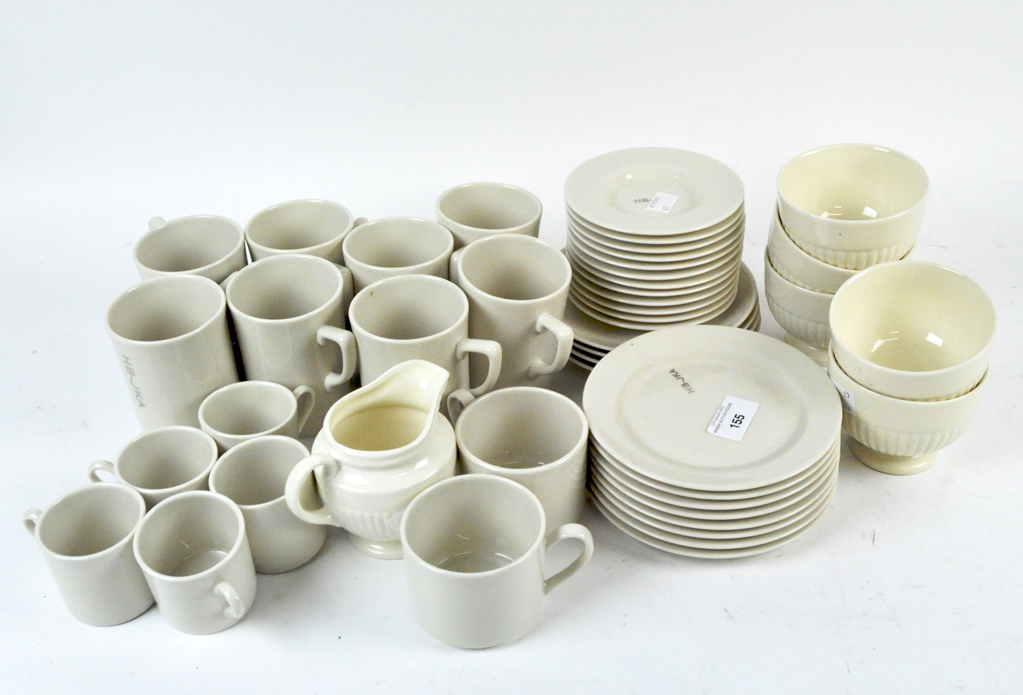 A part tea set by Pickard and some Wedgwood tea items, both with a cream glaze,