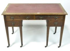 A mahogany writing table, the rectangular top inset with red leather,