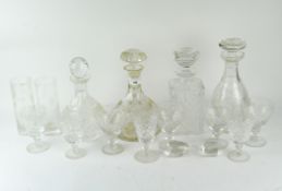 A collection of cut glassware including four decanters and various glasses,