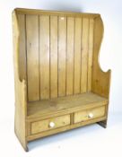 A late 19th/early 20th century two seater pine settle,