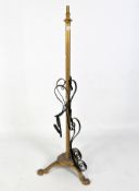 A gilt metal painted standard lamp, raised upon tripod lion paw feet,