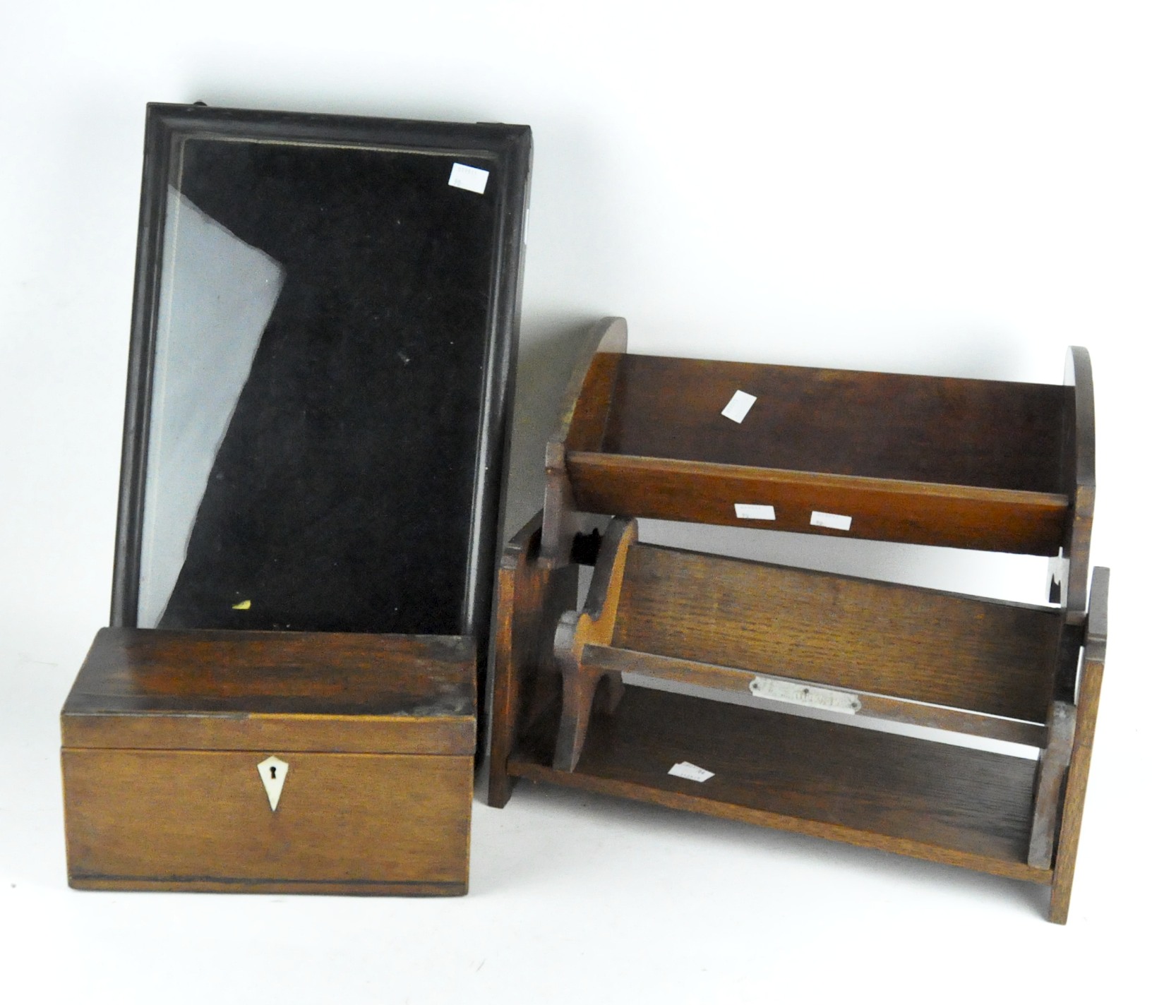 A group of vintage wooden items, including a tea chest, wall display case, book rests and book end