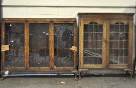 Two early 20th century display cabinets, one being oak, both glazed,