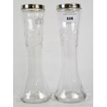 A pair of early 20th century silver topped vases, with moulded decoration,