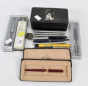 A collection of vintage pens, including Parker ball point and fountain pens,