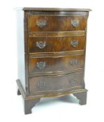 A small 20th century bow fronted chest of drawers with five drawers over bracket supports,