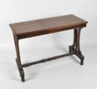 A Victorian mahogany console table of rectangular form, raised upon turned and flowing supports,