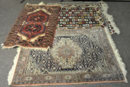A group of three floor rugs,
