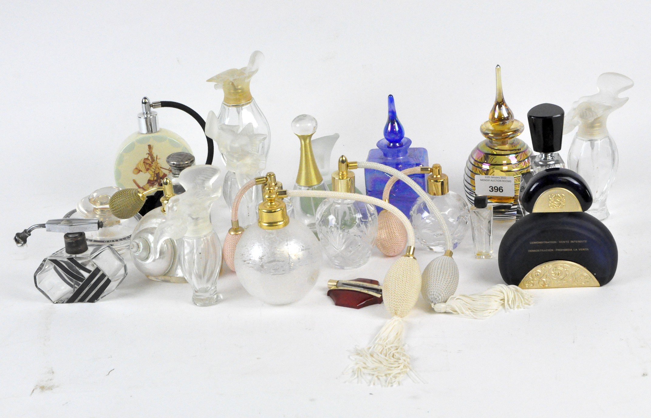 A large collection of assorted perfume bottles, mostly glass,