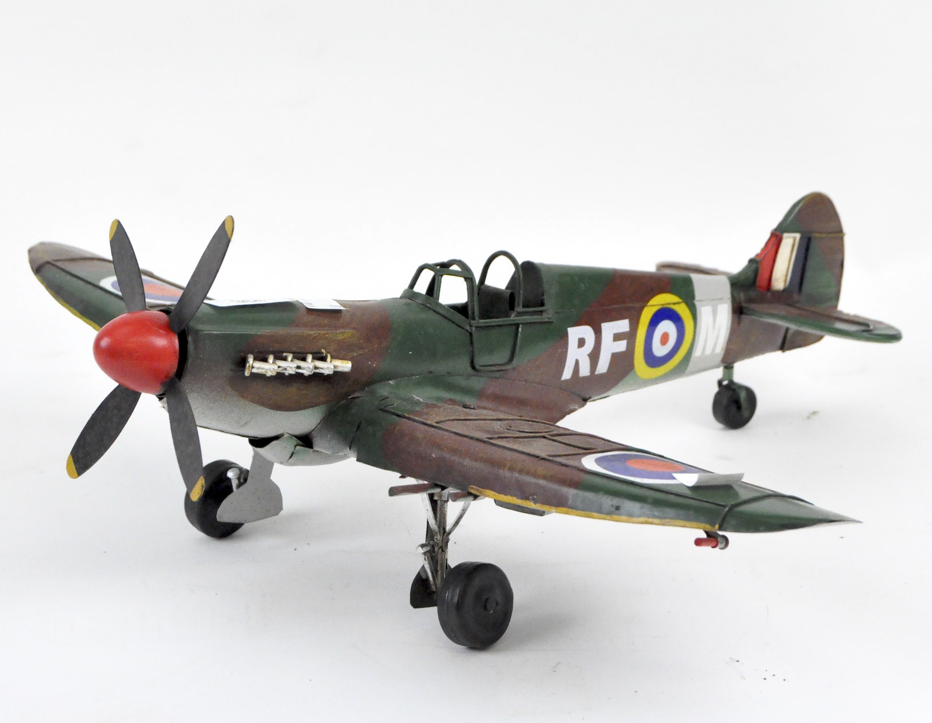 A tinplate model of a spitfire, handpainted with wheels and a rotating propeller,