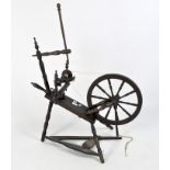 An antique wooden spinning wheel,